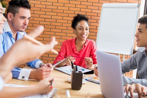 A group of diverse professionals participating in a workplace training session. The facilitator is gesturing towards a slide that reads, 