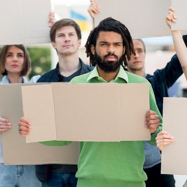 A group of protestors holding signs, with some signs displaying slogans related to corruption and accountability. The atmosphere is charged with emotion and dissent.